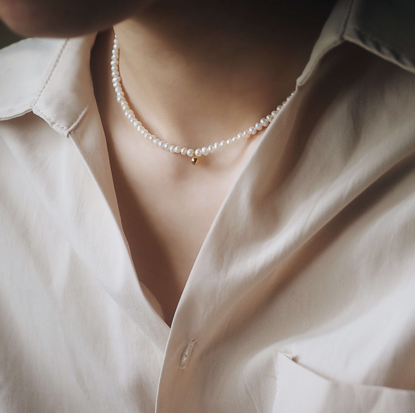 woman-wears-delicate-pearl-necklace.jpg